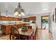 Kitchen features natural wood cabinetry, tile floors, granite countertops, and a view of the pool at 3841 Hildebrand Ln, Las Vegas, NV 89121