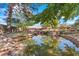 Scenic backyard pond reflects the house amid mature trees and landscaping at 3841 Hildebrand Ln, Las Vegas, NV 89121