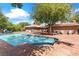 Beautiful backyard pool with stone patio and a brick home in the background at 3841 Hildebrand Ln, Las Vegas, NV 89121