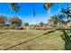 View of a baseball field with surrounding trees and grassy areas at 2368 Winterwood Blvd, Las Vegas, NV 89142