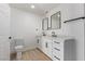 Modern bathroom with a double vanity, white cabinets, and matching mirrors at 2368 Winterwood Blvd, Las Vegas, NV 89142