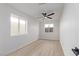 A bedroom featuring new windows, white walls, and modern ceiling fan at 2368 Winterwood Blvd, Las Vegas, NV 89142