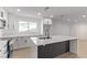 Modern kitchen with white cabinets, a black faucet, and a stylish island at 2368 Winterwood Blvd, Las Vegas, NV 89142