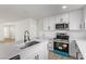 Bright kitchen featuring white cabinets, stainless steel appliances, and a black faucet at 2368 Winterwood Blvd, Las Vegas, NV 89142