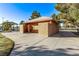 Exterior view of restroom building with tiled roof, brick accents, and a concrete walkway in a well-maintained park setting at 2368 Winterwood Blvd, Las Vegas, NV 89142