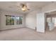 Spacious bedroom with ceiling fan, carpet, and large windows at 2410 Encouraging Ct, Henderson, NV 89052