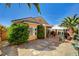 Inviting backyard featuring a covered patio, stone accents and lush landscaping at 2820 Goldcreek St, Henderson, NV 89052