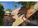 Relaxing backyard with patio area, mature palm trees, and decorative stone wall at 2820 Goldcreek St, Henderson, NV 89052