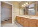 Bathroom with dual sinks, wood cabinets and a walk-in closet at 2820 Goldcreek St, Henderson, NV 89052