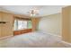 Spacious bedroom with a bay window, custom seat, and ceiling fan at 2820 Goldcreek St, Henderson, NV 89052