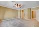 Neutral bedroom featuring carpet, ceiling fan, and entry to the bathroom at 2820 Goldcreek St, Henderson, NV 89052