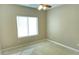 A simple bedroom with a ceiling fan and a large window at 2820 Goldcreek St, Henderson, NV 89052