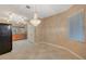 Open dining area with chandelier, tile flooring, and a nearby kitchen at 2820 Goldcreek St, Henderson, NV 89052