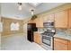 Well-lit kitchen showcasing stainless steel appliances, granite countertops, and tiled floors at 2820 Goldcreek St, Henderson, NV 89052