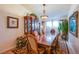 Elegant dining room with wood furniture and large windows at 5912 Sea Hunter St, North Las Vegas, NV 89031