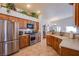 Bright kitchen features stainless steel appliances and warm wood cabinets at 5912 Sea Hunter St, North Las Vegas, NV 89031