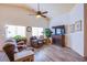 Comfortable living room boasts hardwood floors, a fireplace, and lots of natural light at 5912 Sea Hunter St, North Las Vegas, NV 89031