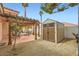 Charming backyard with a shed, gravel landscaping, and covered patio area for outdoor living at 3134 Alfa Romero Ave, North Las Vegas, NV 89031