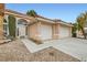 Charming home with a tile roof, manicured front yard, and a two-car garage in a residential neighborhood at 3134 Alfa Romero Ave, North Las Vegas, NV 89031