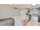 Bright kitchen with tile countertops, stainless steel appliances, and a breakfast bar open to the living room at 3134 Alfa Romero Ave, North Las Vegas, NV 89031