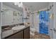 Charming bathroom featuring dark wood vanity, granite countertop, and themed shower curtain at 3573 E Garfield Dr, Pahrump, NV 89061