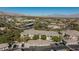 Stunning aerial view of apartment complex with lush landscaping and mountain views at 905 Domnus Ln # 101, Las Vegas, NV 89144