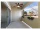 Exterior shot of a balcony with a sliding glass door, ceiling fan, closet, and planted flowers at 905 Domnus Ln # 101, Las Vegas, NV 89144
