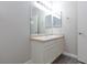 Bright bathroom featuring a vanity with cabinet storage, large mirror, and modern sink at 905 Domnus Ln # 101, Las Vegas, NV 89144