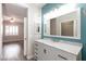 This bathroom has a white marble vanity and is open to the bedroom at 905 Domnus Ln # 101, Las Vegas, NV 89144