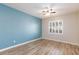 This bedroom features light wood-look flooring and a ceiling fan at 905 Domnus Ln # 101, Las Vegas, NV 89144