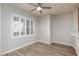 Bedroom with wood floors, white walls, white trim, ceiling fan, and plantation shutters at 905 Domnus Ln # 101, Las Vegas, NV 89144