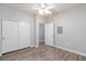 A well-lit bedroom with wood floors, closet, and a ceiling fan at 905 Domnus Ln # 101, Las Vegas, NV 89144