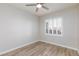 Bedroom with wood floors, white walls, white trim, ceiling fan, and plantation shutters at 905 Domnus Ln # 101, Las Vegas, NV 89144