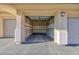 Open garage with a concrete floor and fully paneled walls at 905 Domnus Ln # 101, Las Vegas, NV 89144