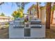 Two stainless steel gas grills on an outdoor kitchen island at 905 Domnus Ln # 101, Las Vegas, NV 89144