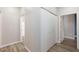 Bright hallway featuring wood floors, white walls and trim, and a closet at 905 Domnus Ln # 101, Las Vegas, NV 89144