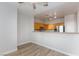 View of a spacious kitchen with wood cabinets, gray countertops, stainless steel appliances, and wood floors at 905 Domnus Ln # 101, Las Vegas, NV 89144