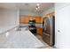 Modern kitchen with stainless steel appliances and granite countertops at 905 Domnus Ln # 101, Las Vegas, NV 89144