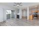 Spacious living room featuring fireplace, hardwood floors, and open kitchen at 905 Domnus Ln # 101, Las Vegas, NV 89144