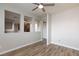 Spacious living room with wood floors, white walls and trim, and a partial kitchen view at 905 Domnus Ln # 101, Las Vegas, NV 89144