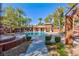 Community pool with poolside seating and lush landscaping at 905 Domnus Ln # 101, Las Vegas, NV 89144