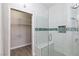 A glass shower features white tile and blue accents plus a walk-in closet at 905 Domnus Ln # 101, Las Vegas, NV 89144