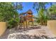 Backyard featuring a wooden play structure and sandpit, ideal for entertainment at 605 Canyon Greens Dr, Las Vegas, NV 89144