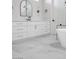 Bright bathroom features marble floors, a white vanity, and a sleek, modern design at 605 Canyon Greens Dr, Las Vegas, NV 89144