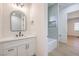 Bathroom with vanity, white countertops, modern black hardware, and an open shower and tub room at 605 Canyon Greens Dr, Las Vegas, NV 89144