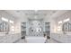 Luxurious bathroom with dual vanities, a soaking tub, a glass shower enclosure, and walk-in closets at 605 Canyon Greens Dr, Las Vegas, NV 89144