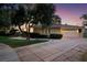 Charming home showcasing a well-maintained lawn, a driveway, and mature trees at 605 Canyon Greens Dr, Las Vegas, NV 89144