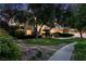 Attractive home exterior with mature trees and professional landscaping at 605 Canyon Greens Dr, Las Vegas, NV 89144
