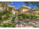 Beautiful home exterior with lush landscaping, a walkway, and an inviting entrance at 605 Canyon Greens Dr, Las Vegas, NV 89144