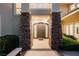 Grand entrance with stone pillars, a modern front door, and a welcoming pathway at 605 Canyon Greens Dr, Las Vegas, NV 89144